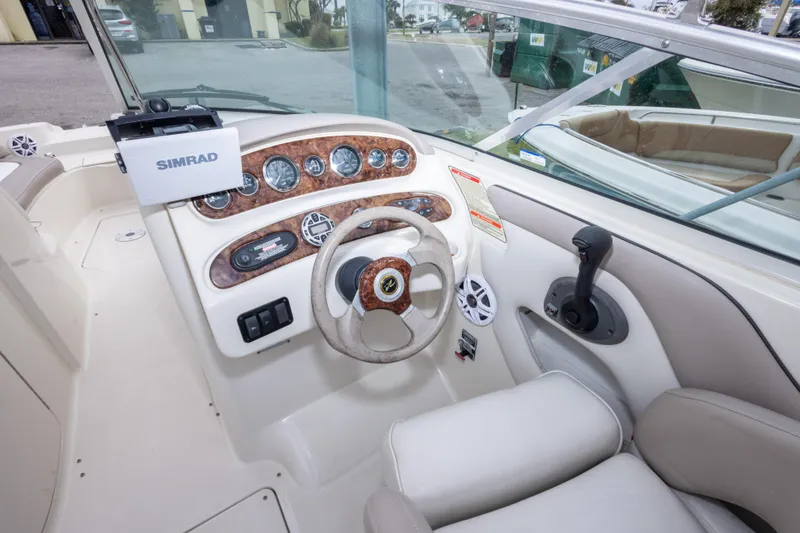 Slide: The Image of Cockpit of 2002 Sea Ray 270 Sundeck with steering wheel and Simrad display. - 16