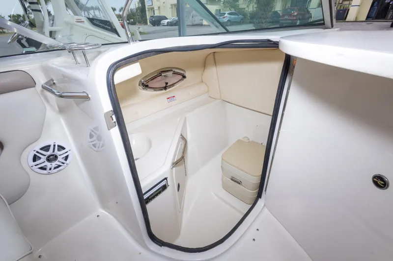 Slide: The Image of Interior of 2002 Sea Ray 270 Sundeck boat featuring compact restroom area. - 18