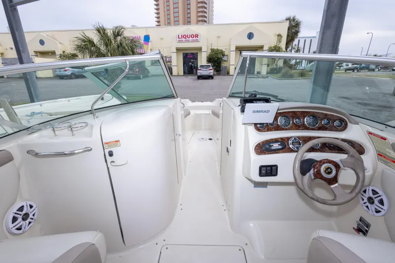 Slide: The Image of 2002 Sea Ray 270 Sundeck boat interior with steering wheel and dashboard controls. - 19