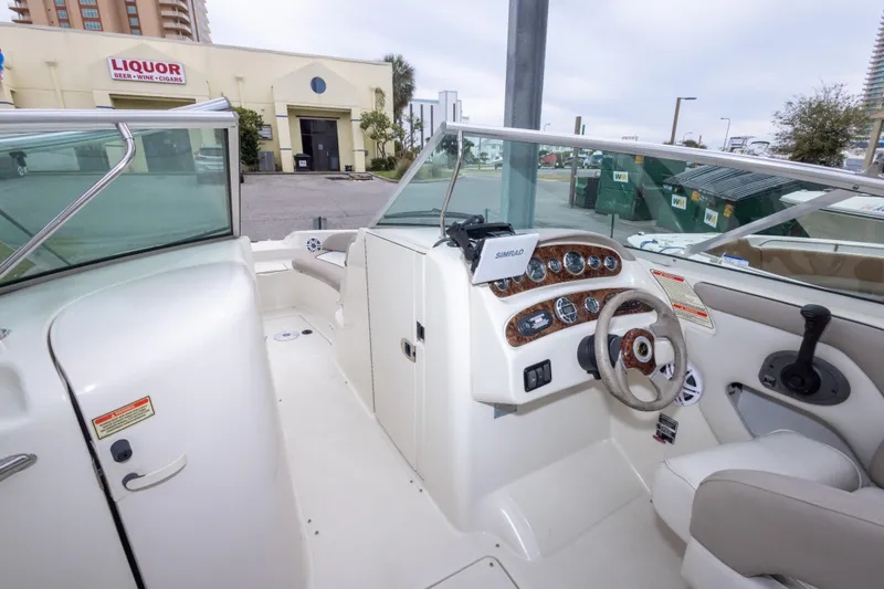 Slide: The Image of 2002 Sea Ray 270 Sundeck boat interior with steering wheel and dashboard controls. - 20