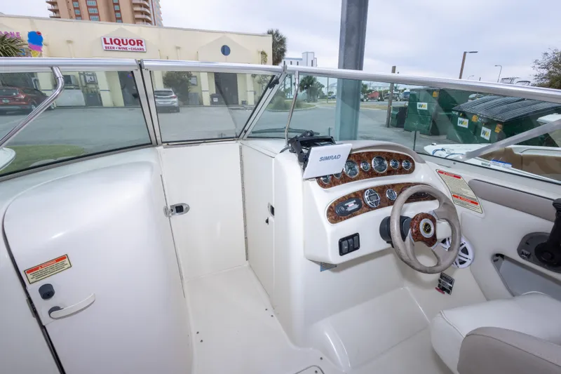 Slide: The Image of Interior view of a 2002 Sea Ray 270 Sundeck boat cockpit with steering wheel and controls. - 21