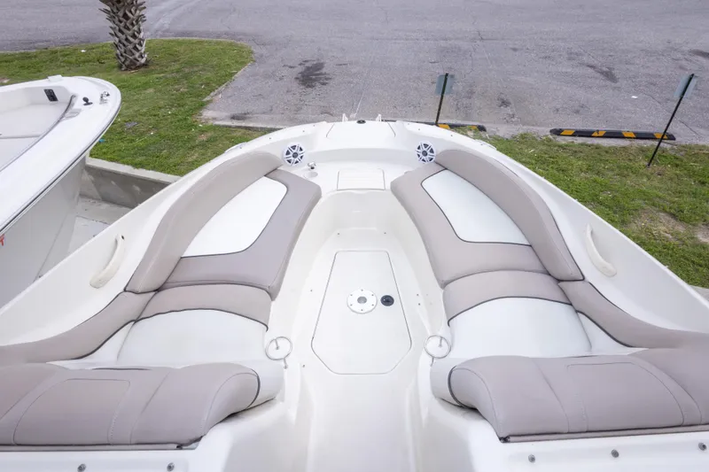 Slide: The Image of 2002 Sea Ray 270 Sundeck boat interior with cushioned seating and speakers. - 22