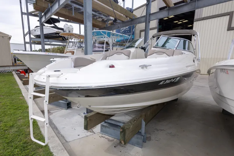 Slide: The Image of 2002 Sea Ray 270 Sundeck boat displayed in a marina storage area. - 25