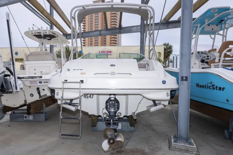Slide: The Image of 2002 Sea Ray 270 Sundeck boat in storage, rear view with outboard motor. - 29