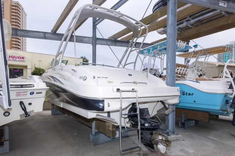Slide: The Image of 2002 Sea Ray 270 Sundeck boat in storage, featuring sleek design and sturdy build. - 30