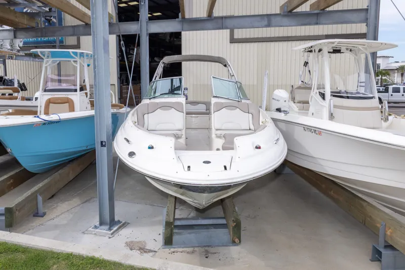 Slide: The Image of 2002 Sea Ray 270 Sundeck boat displayed in a marina storage area. - 33