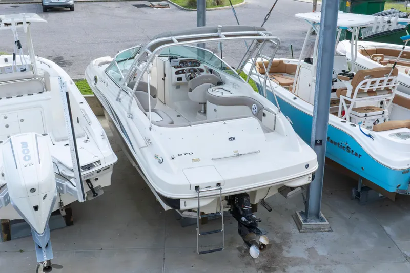 Slide: The Image of 2002 Sea Ray 270 Sundeck boat in storage, surrounded by other boats. - 35