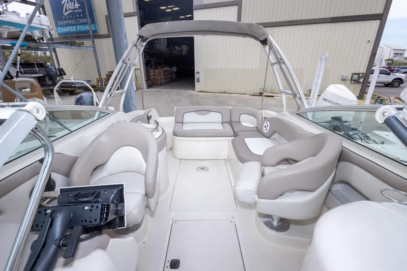 Slide: The Image of 2002 Sea Ray 270 Sundeck boat interior with beige seating and canopy. - 7