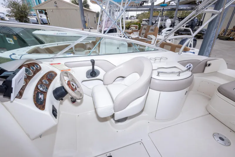 Slide: The Image of 2002 Sea Ray 270 Sundeck cockpit with steering wheel, controls, and seating. - 8