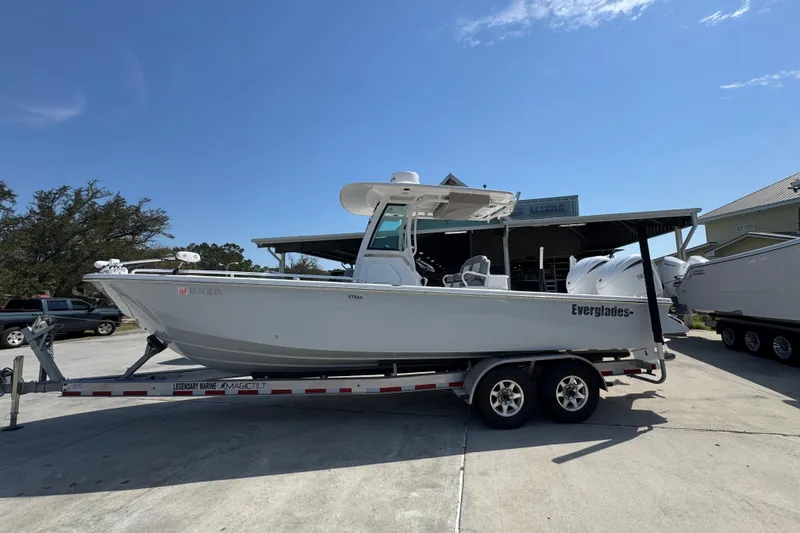 The Image of 2023 Everglades 273 Center Console boat on trailer under clear blue sky. - 1