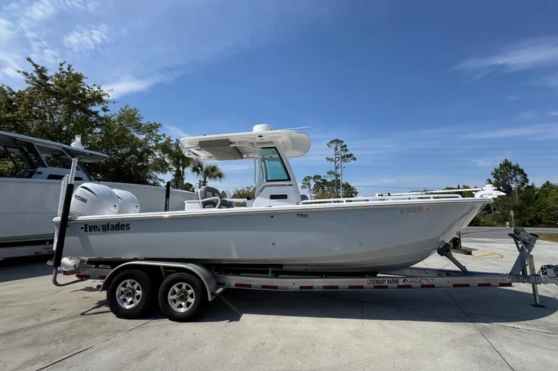 Slide: The Image of 2023 Everglades 273 Center Console boat on trailer under clear blue sky. - 11