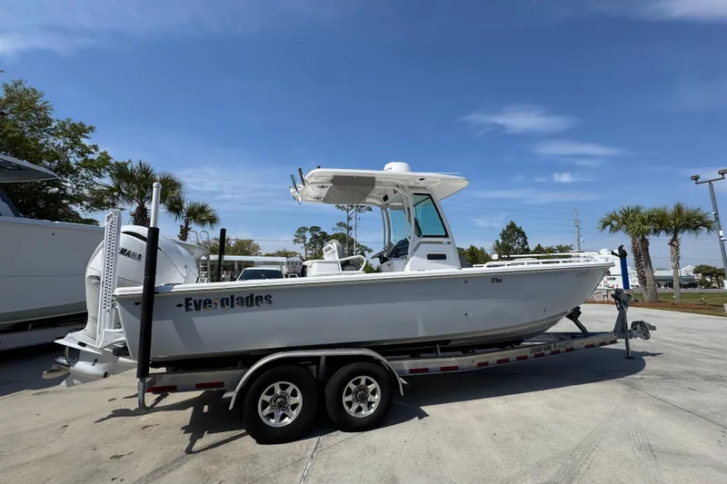 Slide: The Image of 2023 Everglades 273 Center Console boat on trailer under clear blue sky. - 12