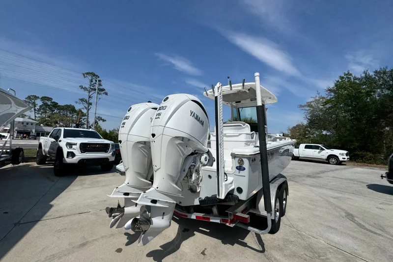 Slide: The Image of 2023 Everglades 273 Center Console boat with twin Yamaha engines on a trailer. - 14