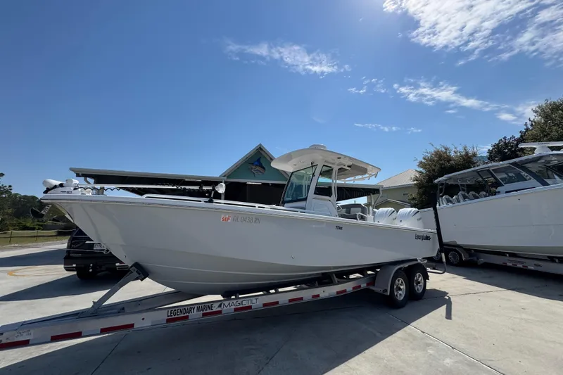 Slide: The Image of 2023 Everglades 273 Center Console boat on trailer under clear blue sky. - 3