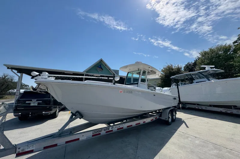 Slide: The Image of 2023 Everglades 273 Center Console boat on trailer under clear sky. - 4
