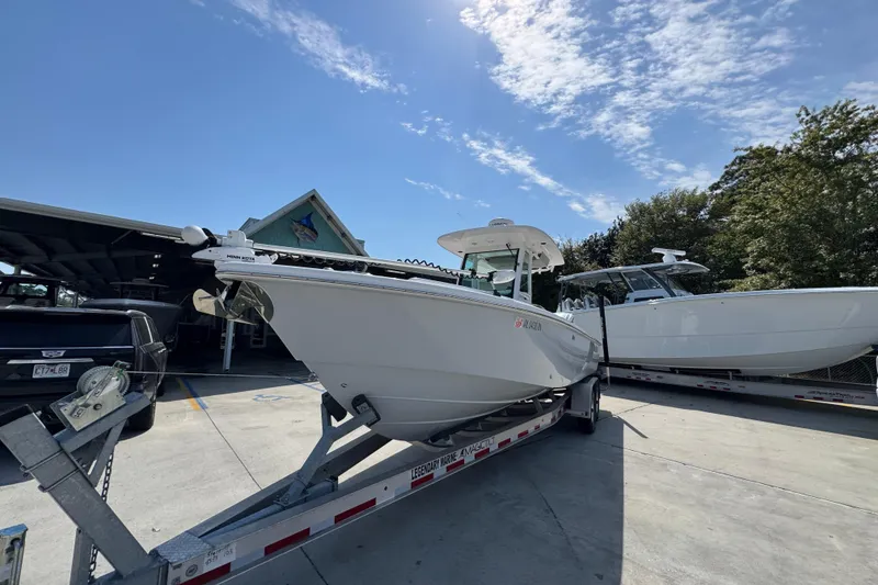 Slide: The Image of 2023 Everglades 273 Center Console boat on trailer under clear sky. - 5
