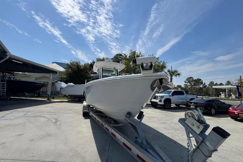 Slide: The Image of 2023 Everglades 273 Center Console boat on trailer under clear blue sky. - 8