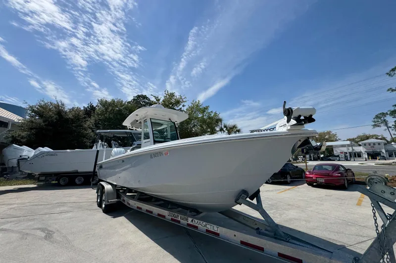 Slide: The Image of 2023 Everglades 273 Center Console boat on trailer under clear blue sky. - 9