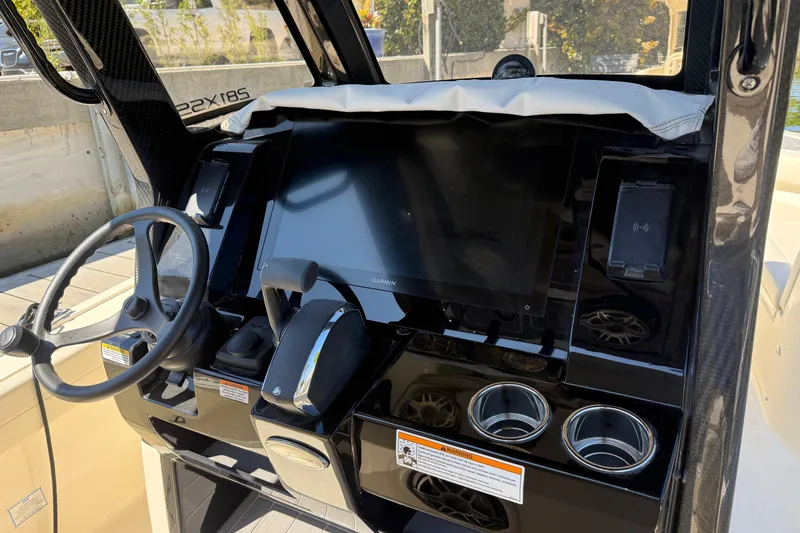Slide: The Image of 2026 Scout 281 XSS boat dashboard with steering wheel and touchscreen display. - 10