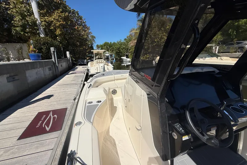 Slide: The Image of 2026 Scout 281 XSS boat docked, showcasing sleek design and modern dashboard. - 11