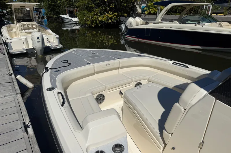 Slide: The Image of 2026 Scout 281 XSS boat docked, featuring spacious seating and sleek design. - 12