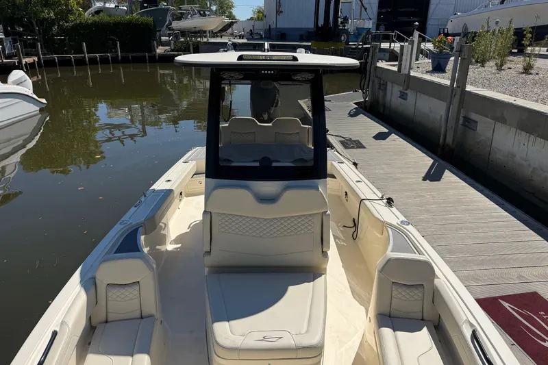 Slide: The Image of 2026 Scout 281 XSS boat docked, featuring spacious seating and sleek design. - 15