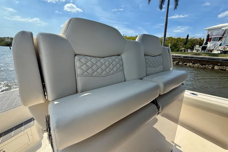 Slide: The Image of 2026 Scout 281 XSS boat seats with quilted design, set against a scenic waterfront backdrop. - 17