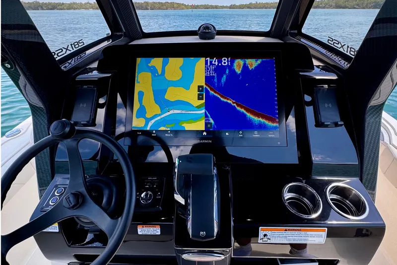 Slide: The Image of Cockpit of 2026 Scout 281 XSS boat with advanced navigation display and steering wheel. - 19