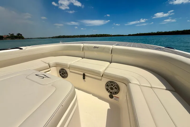 Slide: The Image of 2026 Scout 281 XSS boat interior with luxurious seating on a sunny day. - 22
