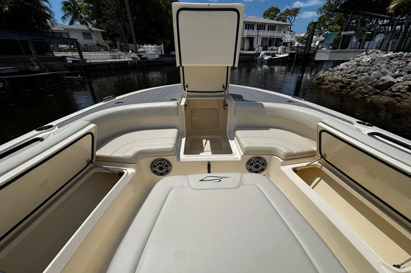 Slide: The Image of 2026 Scout 281 XSS boat interior with open storage compartments and seating. - 24