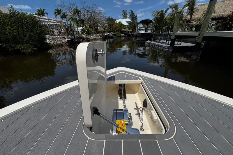 Slide: The Image of 2026 Scout 281 XSS boat with open hatch, docked in a scenic canal setting. - 25
