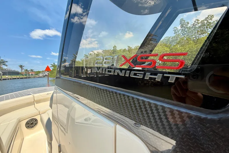 Slide: The Image of 2026 Scout 281 XSS Midnight boat with sleek design and waterfront view. - 26