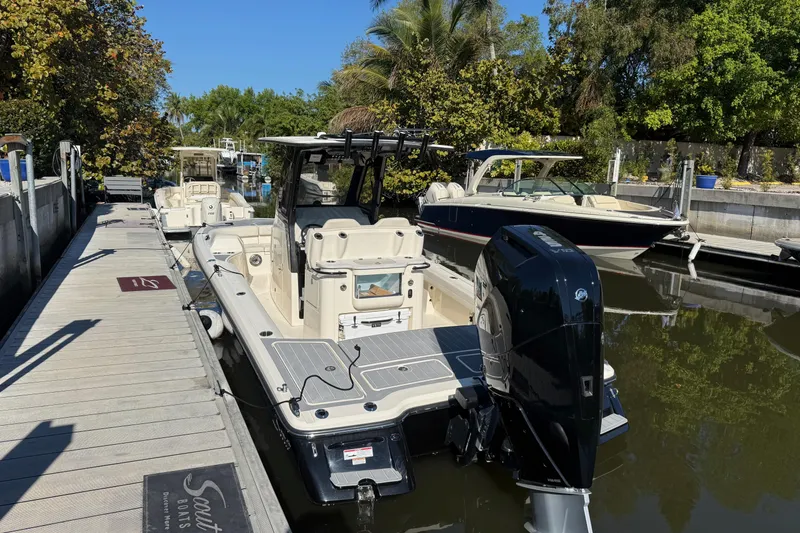 Slide: The Image of 2026 Scout 281 XSS boat docked in a scenic marina setting. - 4