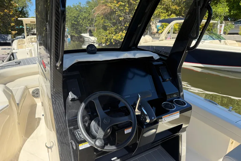 Slide: The Image of 2026 Scout 281 XSS boat cockpit with steering wheel and control panel. - 8