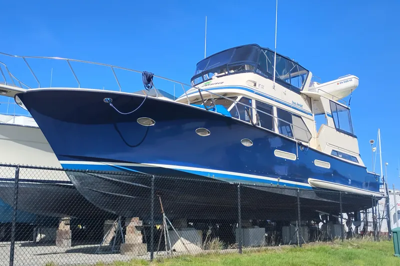 Slide: The Image of 1988 PT 52 AFT Cabin Motor Yacht on dry dock, blue hull, sunny day. - 1