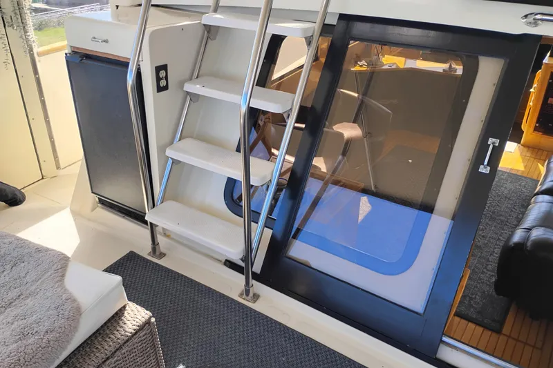 Slide: The Image of 1988 PT 52 AFT Cabin Motor Yacht interior with stairs and seating area. - 10