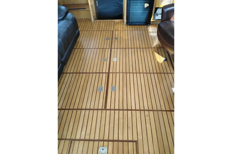 Slide: The Image of Teak flooring inside 1988 PT 52 AFT Cabin Motor Yacht, featuring sleek wood paneling. - 102