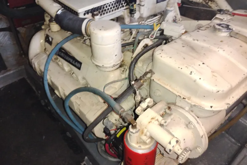 Slide: The Image of Engine of 1988 PT 52 AFT Cabin Motor Yacht, showing mechanical components and hoses. - 103