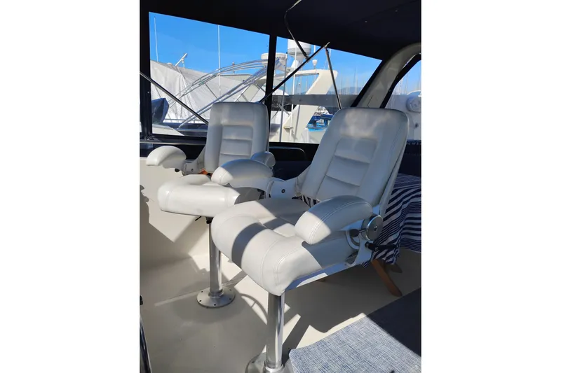 Slide: The Image of White captain chairs on 1988 PT 52 AFT Cabin Motor Yacht deck. - 14