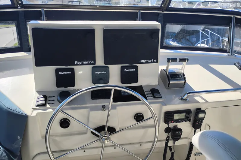 Slide: The Image of 1988 PT 52 AFT Cabin Motor Yacht helm with Raymarine navigation equipment. - 16