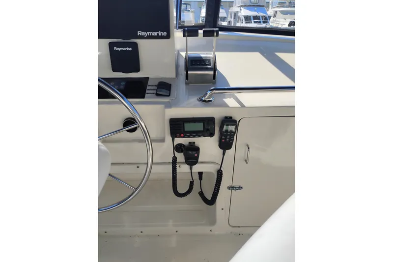 Slide: The Image of 1988 PT 52 AFT Cabin Motor Yacht helm with Raymarine equipment and communication devices. - 17