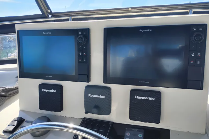 Slide: The Image of Helm of 1988 PT 52 AFT Cabin Motor Yacht with Raymarine navigation displays. - 18