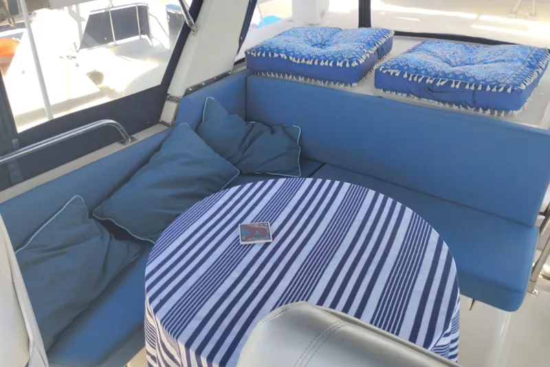 Slide: The Image of Cozy seating area on 1988 PT 52 AFT Cabin Motor Yacht with striped tablecloth. - 25