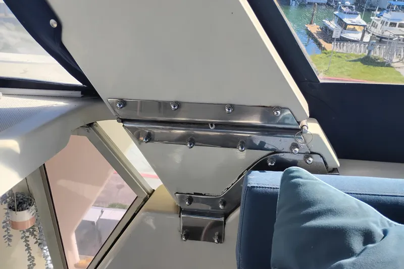 Slide: The Image of Interior view of 1988 PT 52 AFT Cabin Motor Yacht with metal fittings and blue cushion. - 29