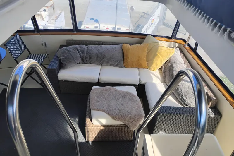 Slide: The Image of Cozy seating area on 1988 PT 52 AFT Cabin Motor Yacht with cushions and blankets. - 30
