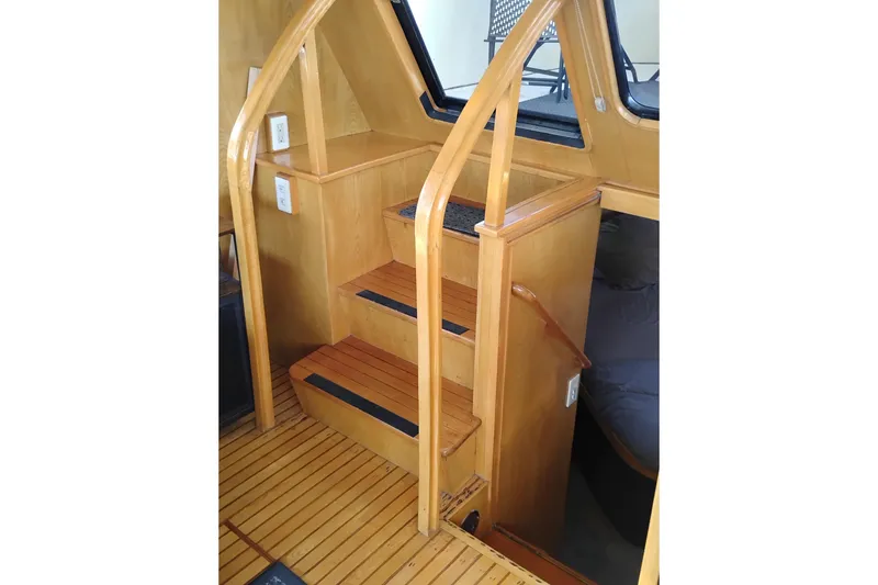 Slide: The Image of Wooden staircase inside 1988 PT 52 AFT Cabin Motor Yacht, featuring sleek design and craftsmanship. - 32