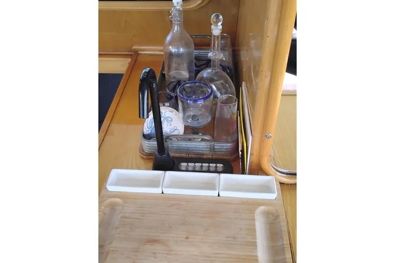 Slide: The Image of Galley area of 1988 PT 52 AFT Cabin Motor Yacht with glassware and wooden countertop. - 36