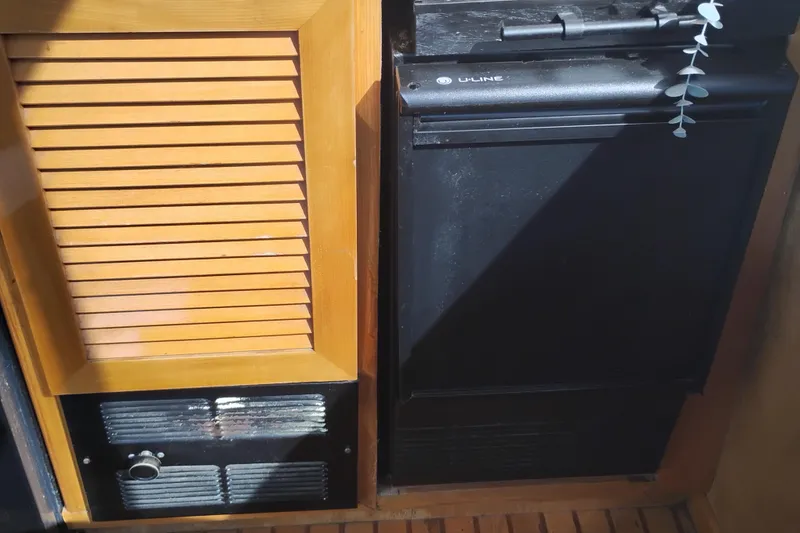 Slide: The Image of 1988 PT 52 AFT Cabin Motor Yacht interior with wooden panel and black appliance. - 38