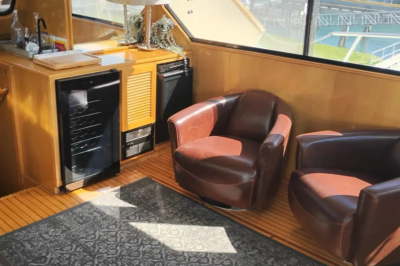 Slide: The Image of Luxurious interior of 1988 PT 52 AFT Cabin Motor Yacht with leather chairs and mini fridge. - 39