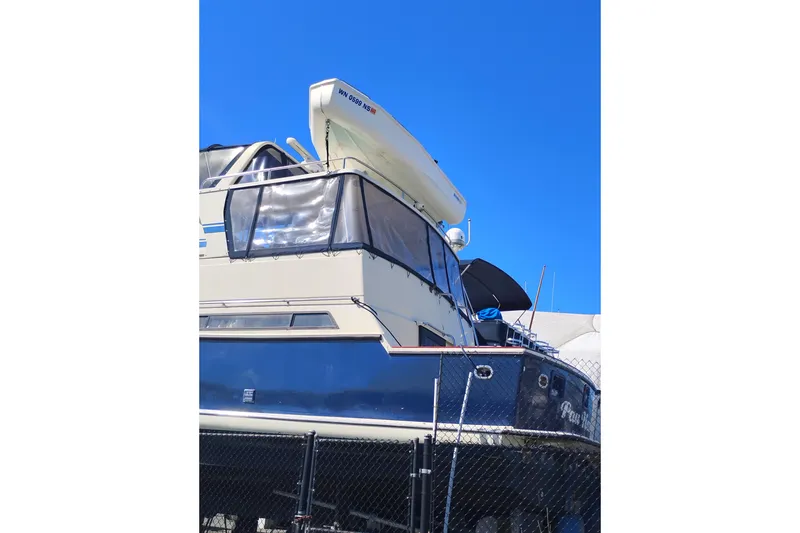 Slide: The Image of 1988 PT 52 AFT Cabin Motor Yacht docked under clear blue sky. - 4